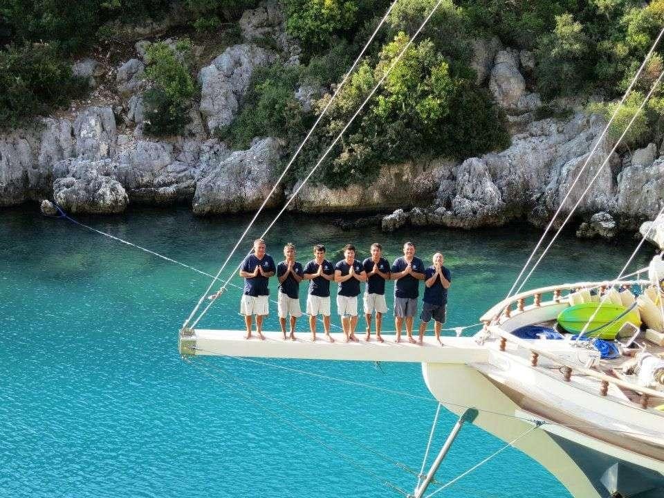 a group of people standing on a dock on a boat aboard TERSANE 8 Yacht for Charter