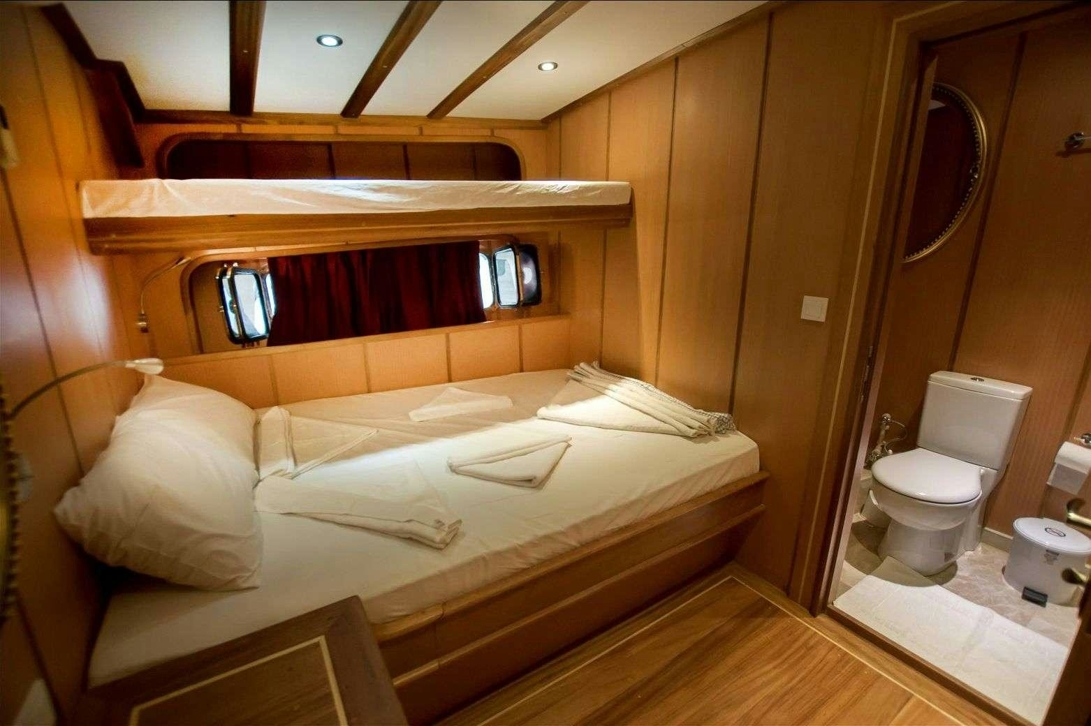 a room with a bed and a mirror aboard TERSANE 8 Yacht for Charter