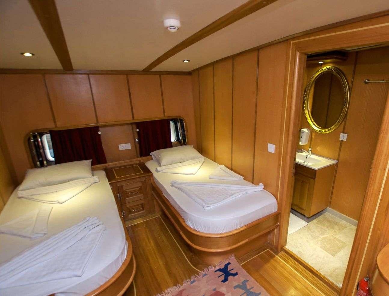 a hotel room with two beds aboard TERSANE 8 Yacht for Charter