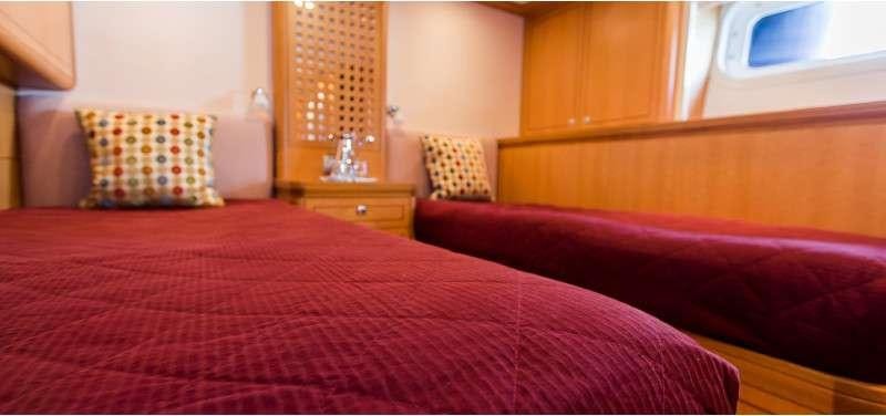 a room with a bed and a mirror aboard MARGARET ANN Yacht for Charter