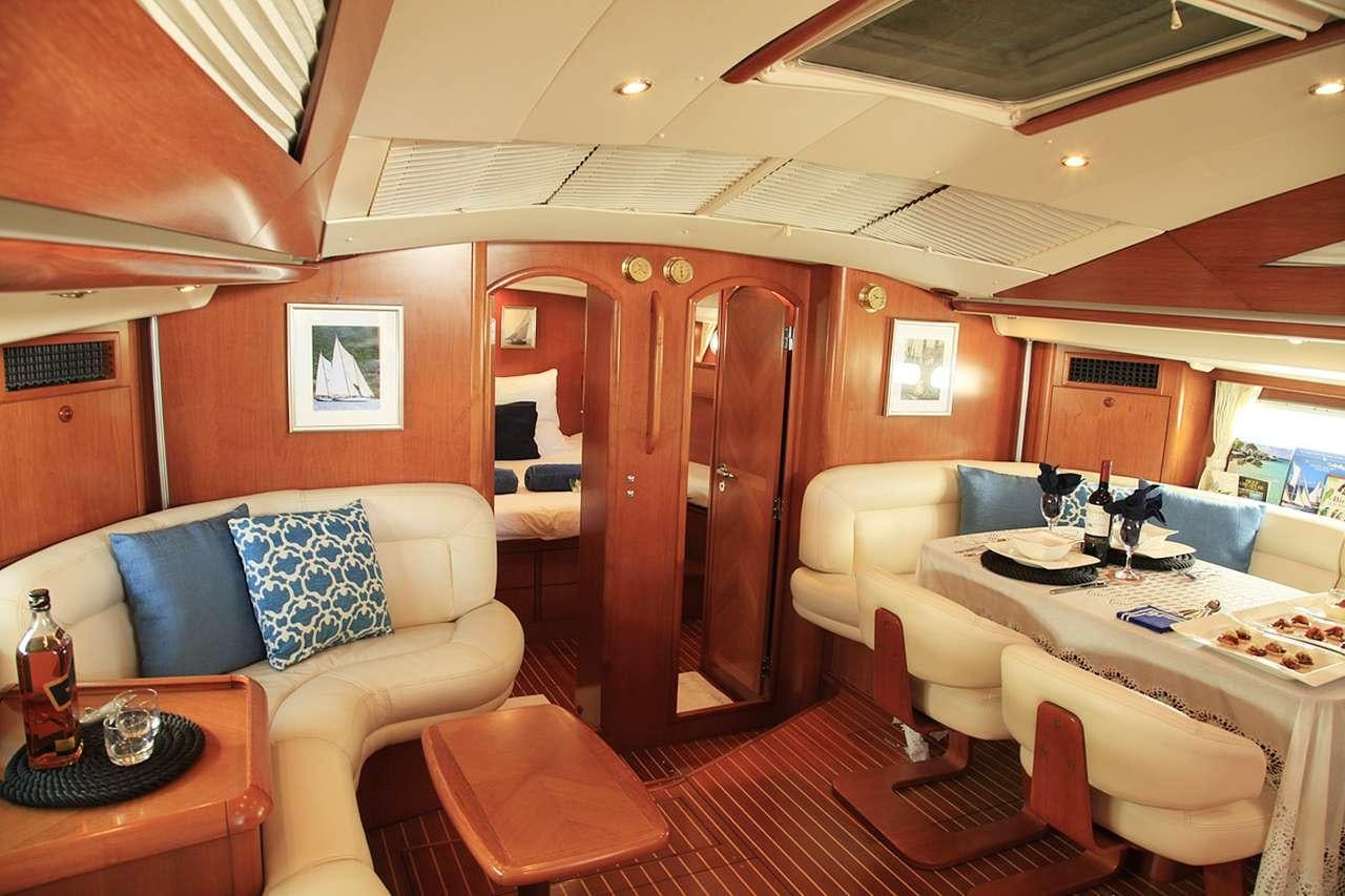 a room with a table and chairs aboard SAYANG Yacht for Charter