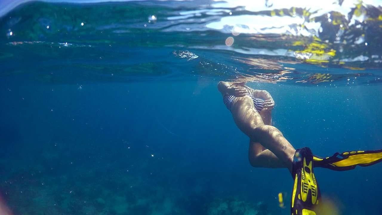 a person swimming in the water aboard SAYANG Yacht for Charter