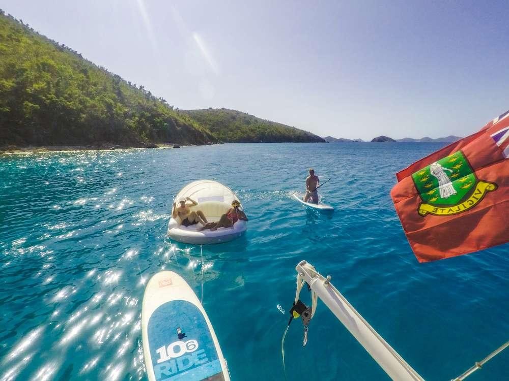 a person and a dog in a boat on the water aboard SAYANG Yacht for Charter