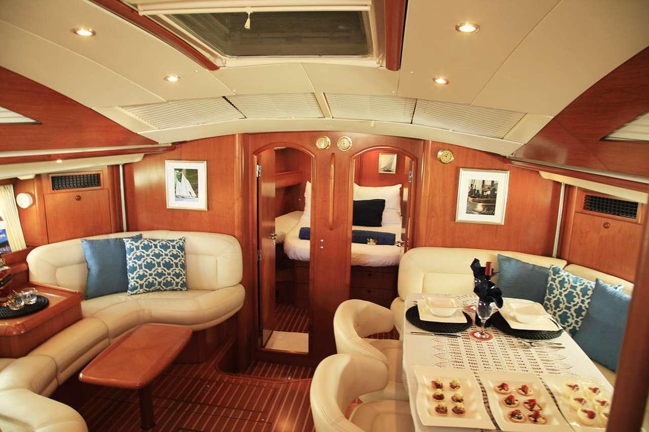 a room with a bed and a couch aboard SAYANG Yacht for Charter