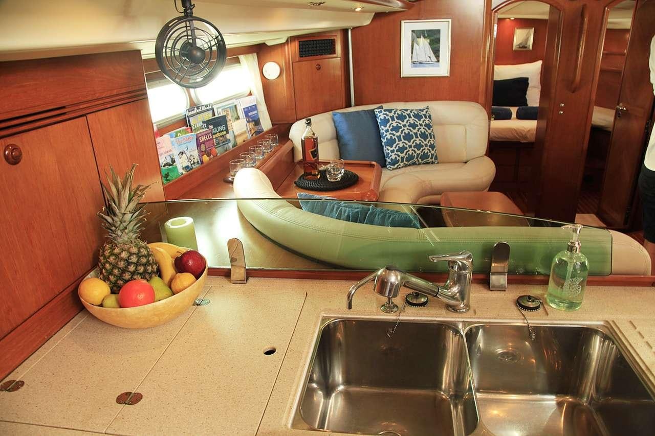 a kitchen with a table and a sink aboard SAYANG Yacht for Charter