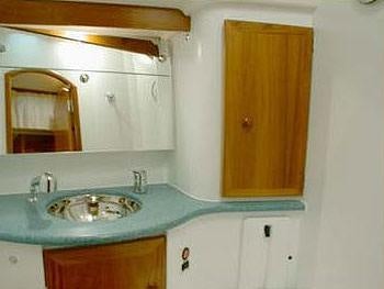 a bathroom with a sink and cabinets aboard SAYANG Yacht for Charter