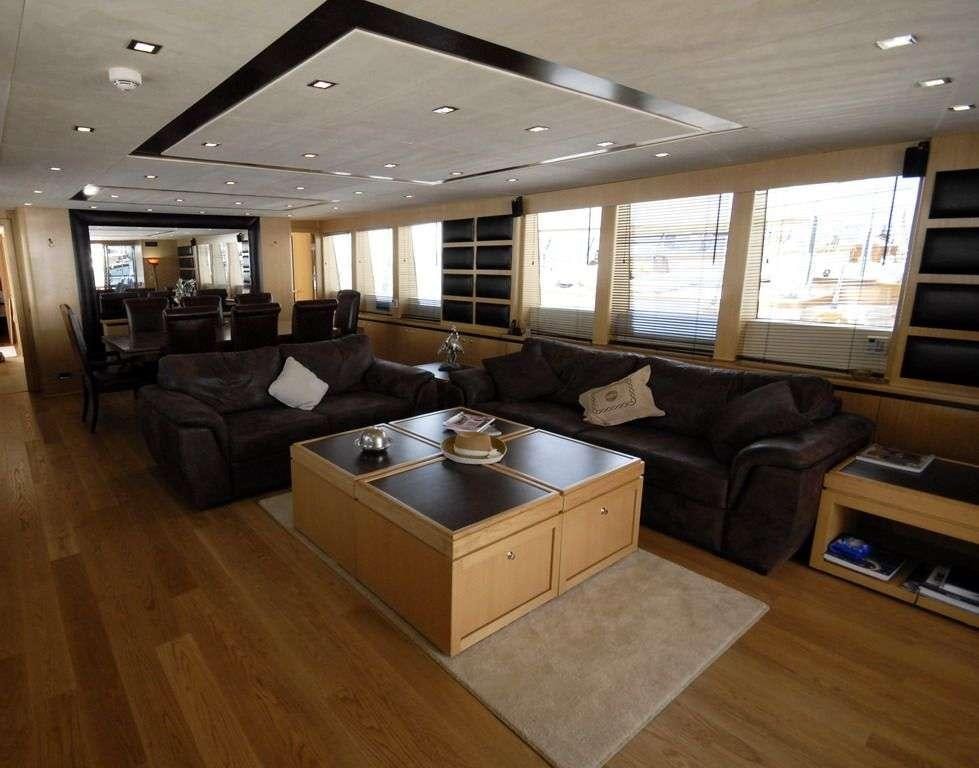 a living room with leather couches and a coffee table aboard SMYRNA Yacht for Charter