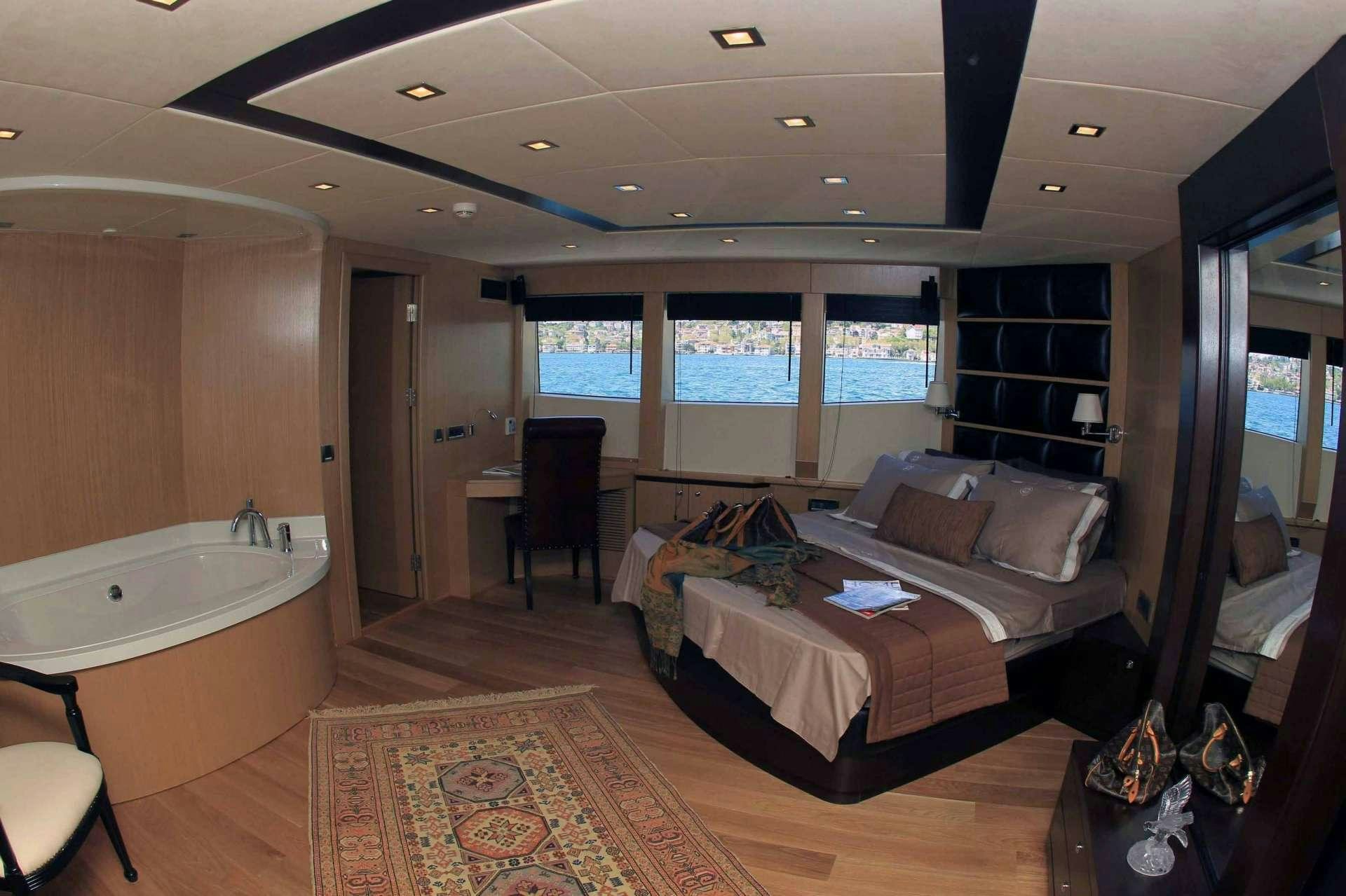 a room with a bed and a couch aboard SMYRNA Yacht for Charter
