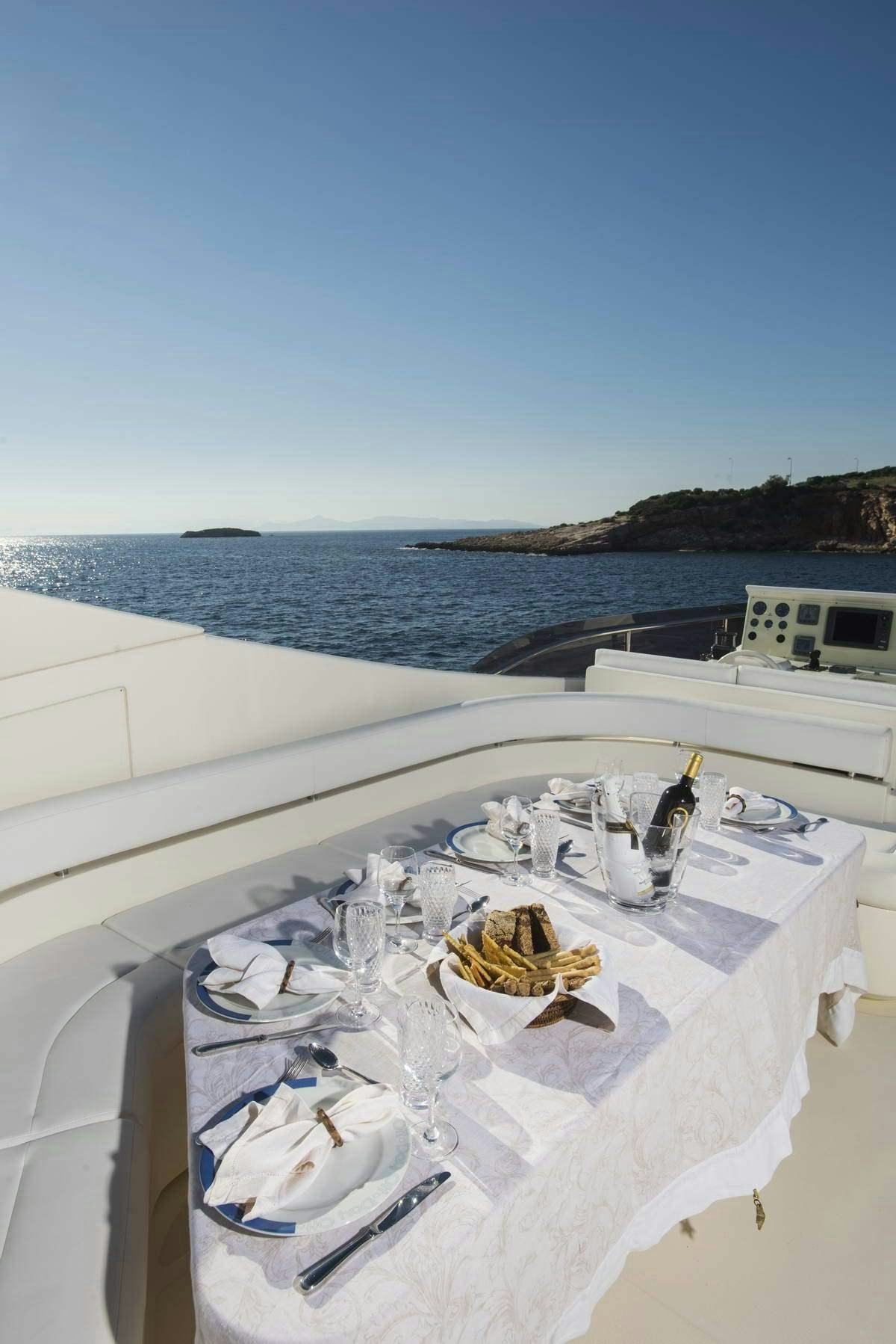 a white table with a white tablecloth with a white tablecloth and a white tablecloth with aboard DAY OFF Yacht for Charter