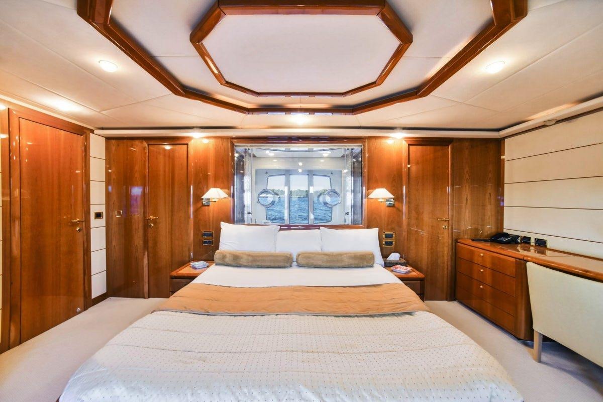 a room with a bed and a desk aboard DAY OFF Yacht for Charter