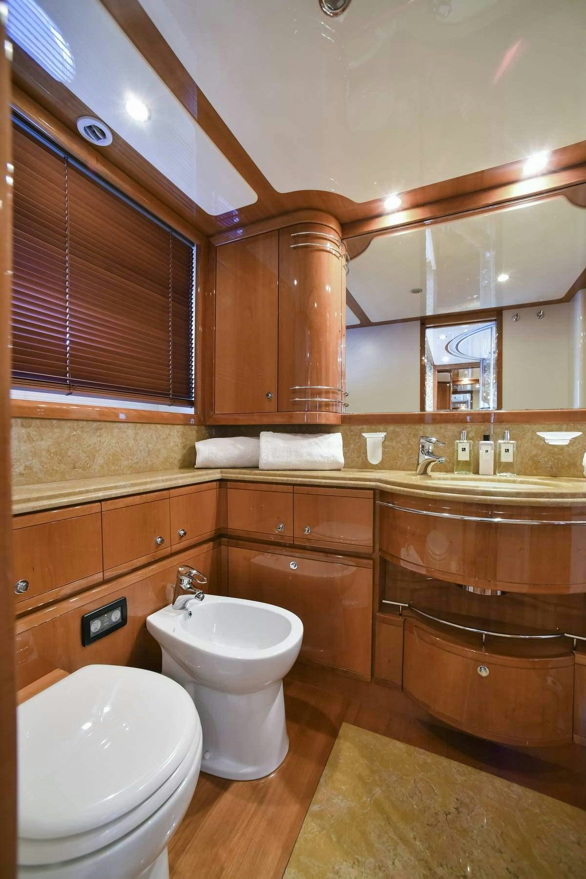 a bathroom with wooden cabinets aboard DAY OFF Yacht for Charter