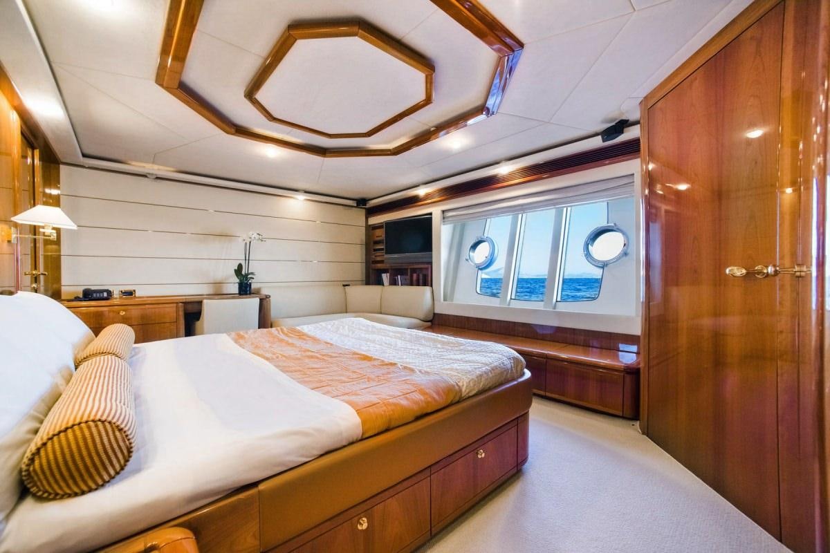 a room with a bed and a wood door aboard DAY OFF Yacht for Charter