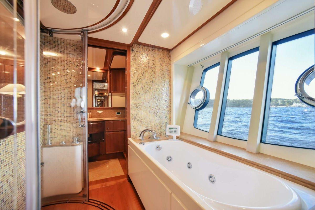 a bathroom with a bathtub and shower aboard DAY OFF Yacht for Charter