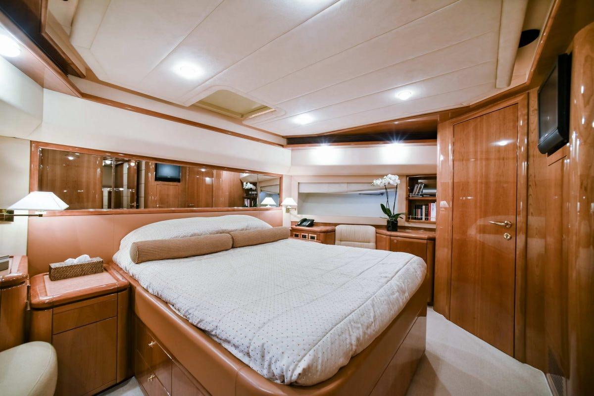 a bedroom with a bed and a desk aboard DAY OFF Yacht for Charter