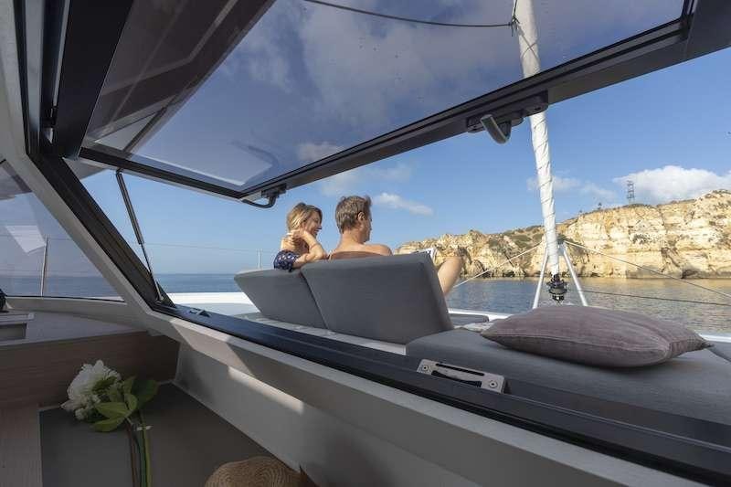 a couple of people sitting in a convertible car aboard CHAMPAGNE Yacht for Charter