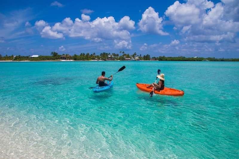 a man and a woman in a canoe in the water aboard CHAMPAGNE Yacht for Charter