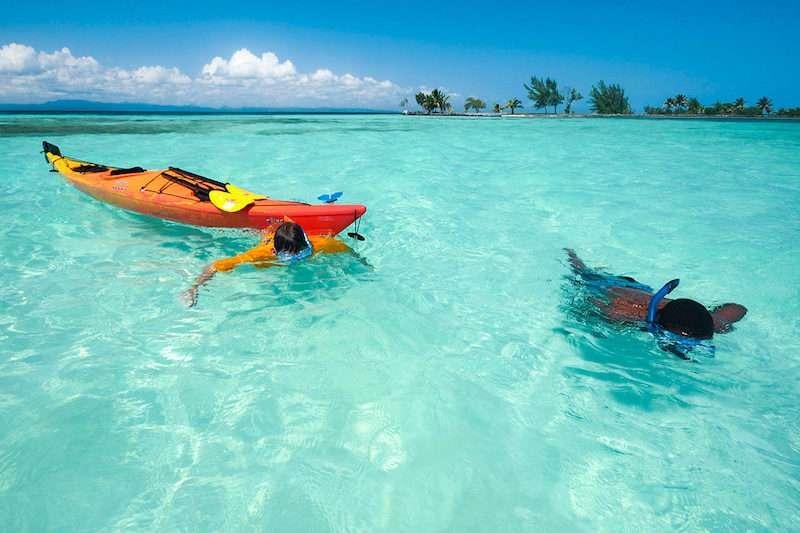 a group of people swimming in a body of water with boats in it aboard CHAMPAGNE Yacht for Charter