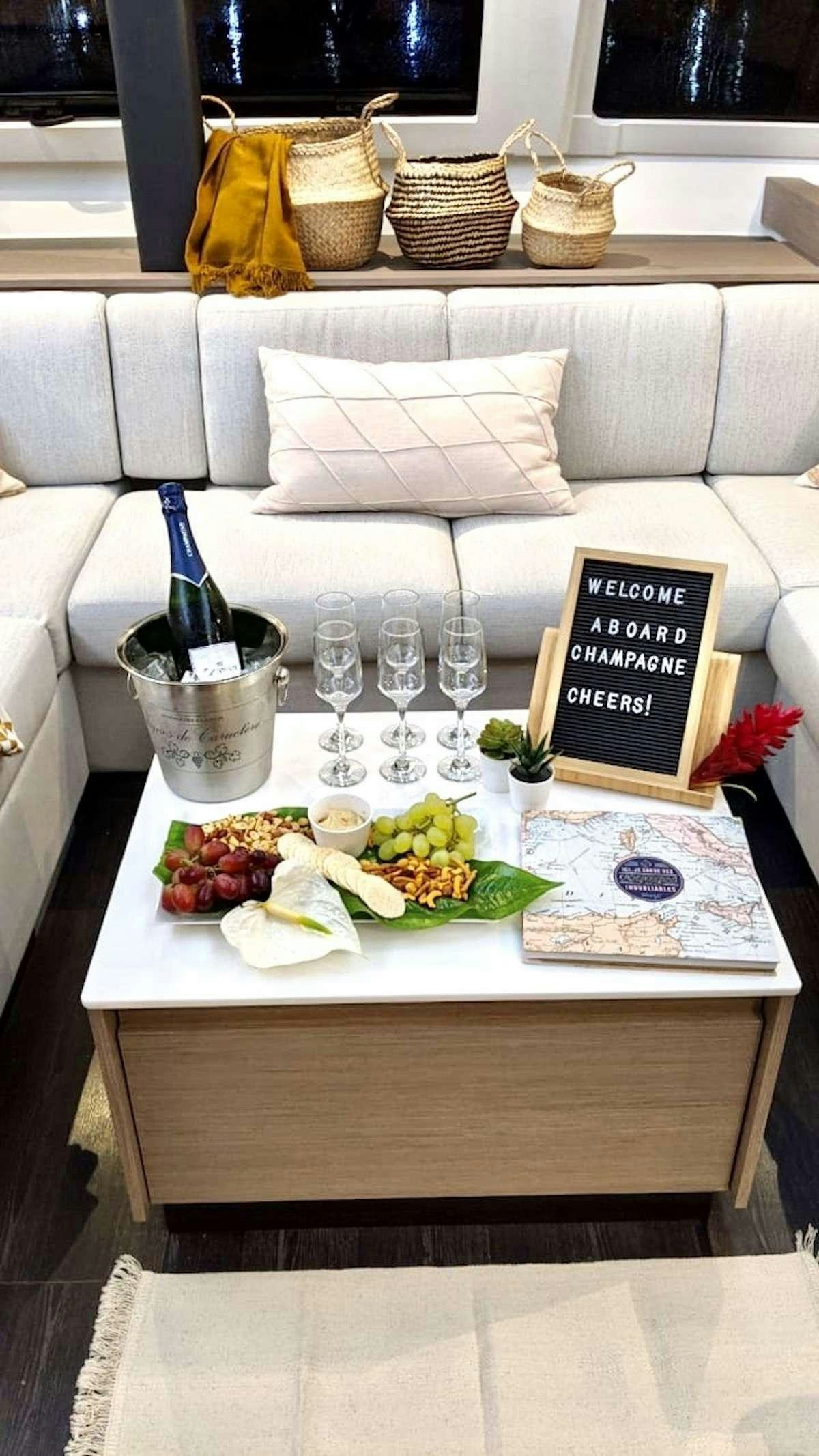 a table with food and wine glasses aboard CHAMPAGNE Yacht for Charter