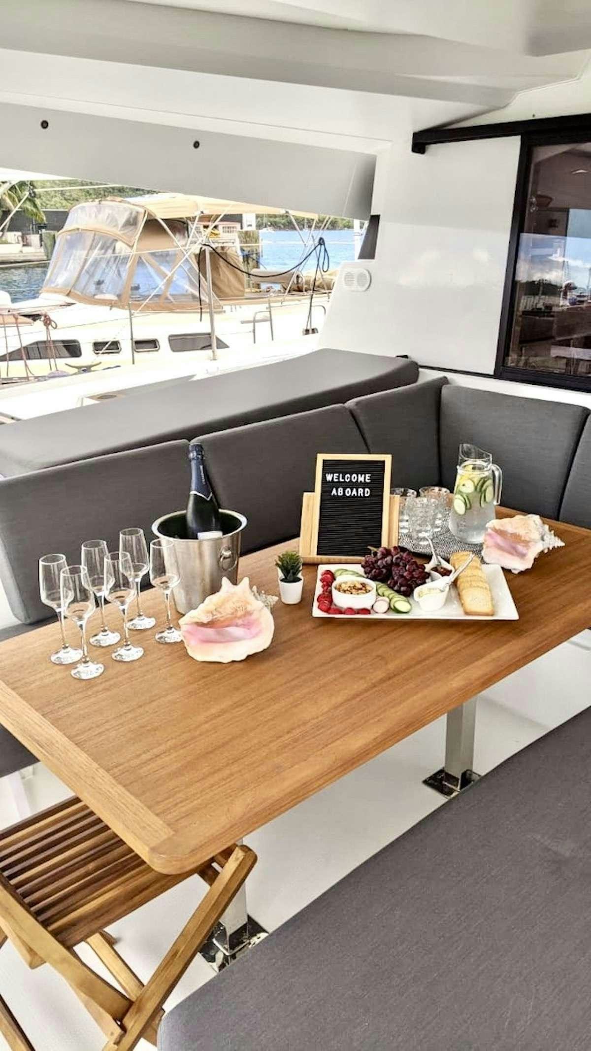 a table with food and wine glasses aboard CHAMPAGNE Yacht for Charter