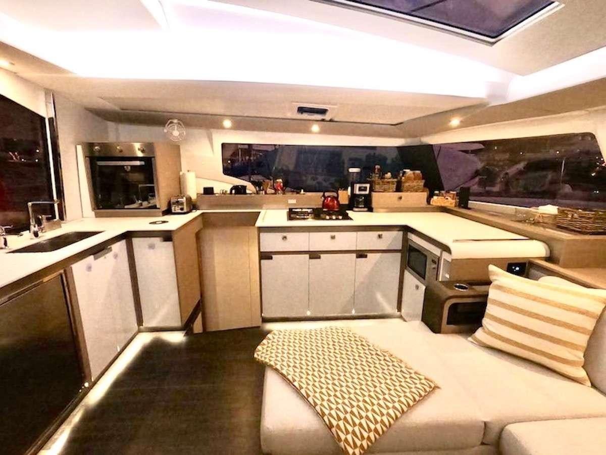 a kitchen with a couch and a tv aboard CHAMPAGNE Yacht for Charter