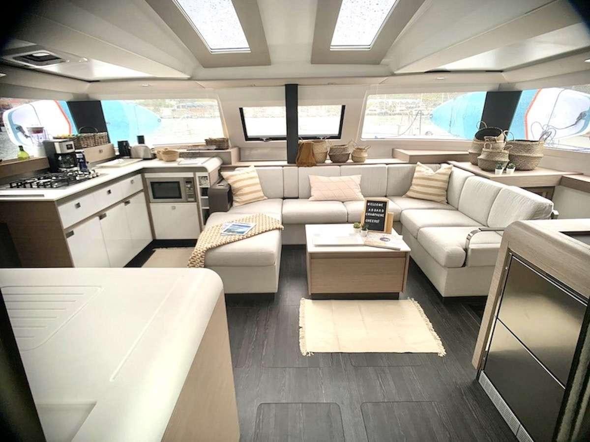 a living room with a couch and a table aboard CHAMPAGNE Yacht for Charter