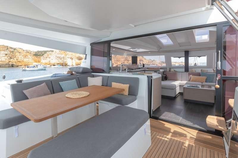 a room with a table and couches aboard CHAMPAGNE Yacht for Charter