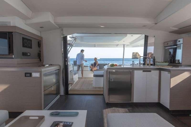a couple of people in a large kitchen aboard CHAMPAGNE Yacht for Charter