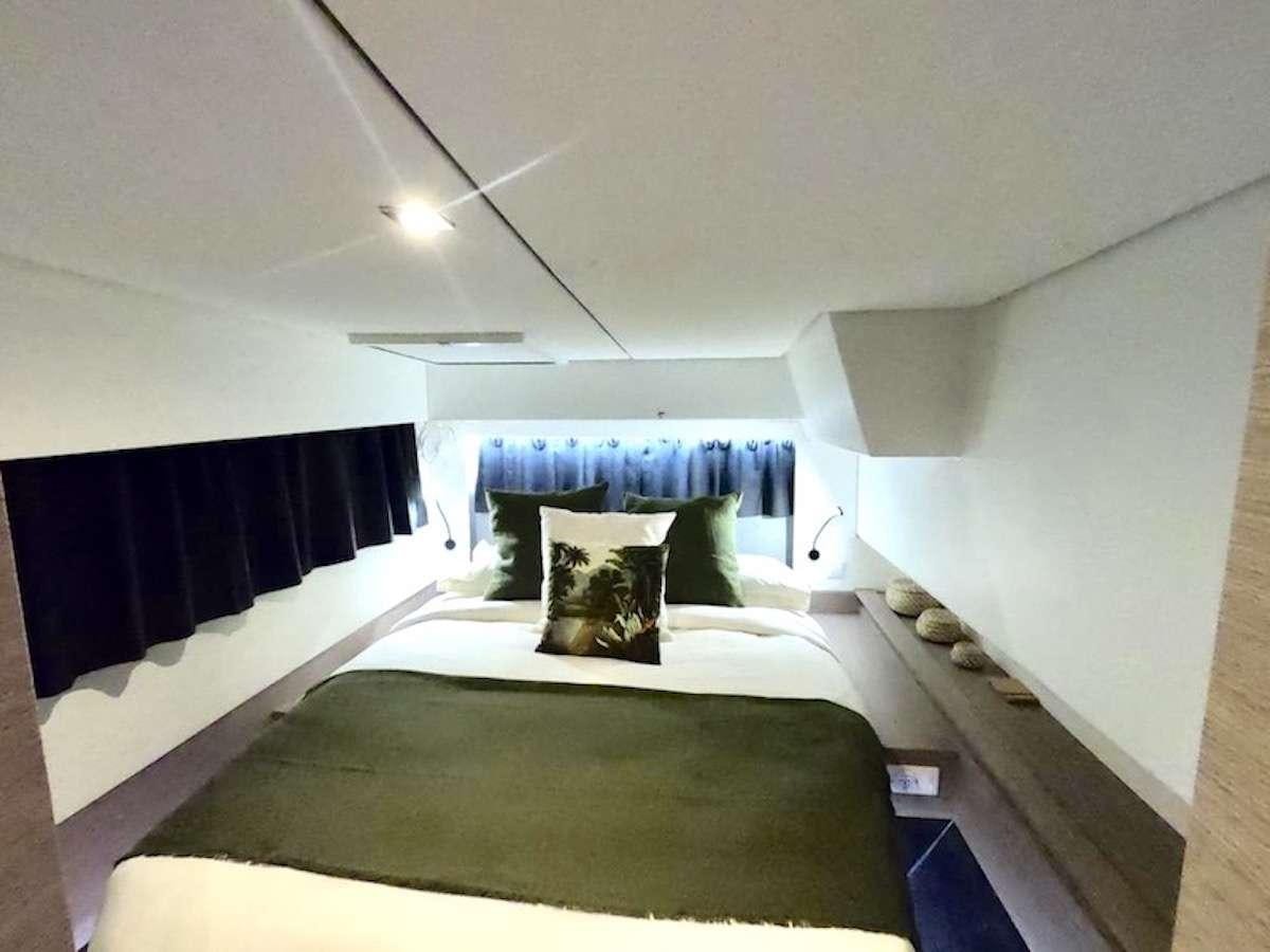 a bedroom with two beds aboard CHAMPAGNE Yacht for Charter
