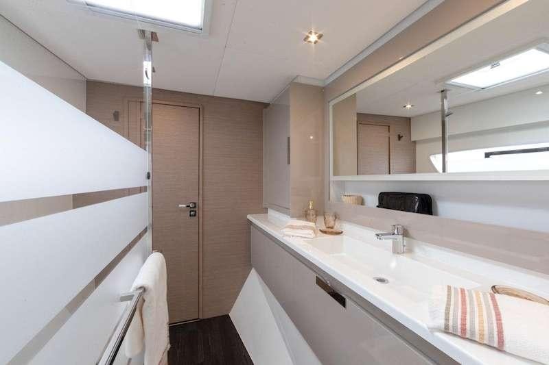 a bathroom with a sink and a mirror aboard CHAMPAGNE Yacht for Charter