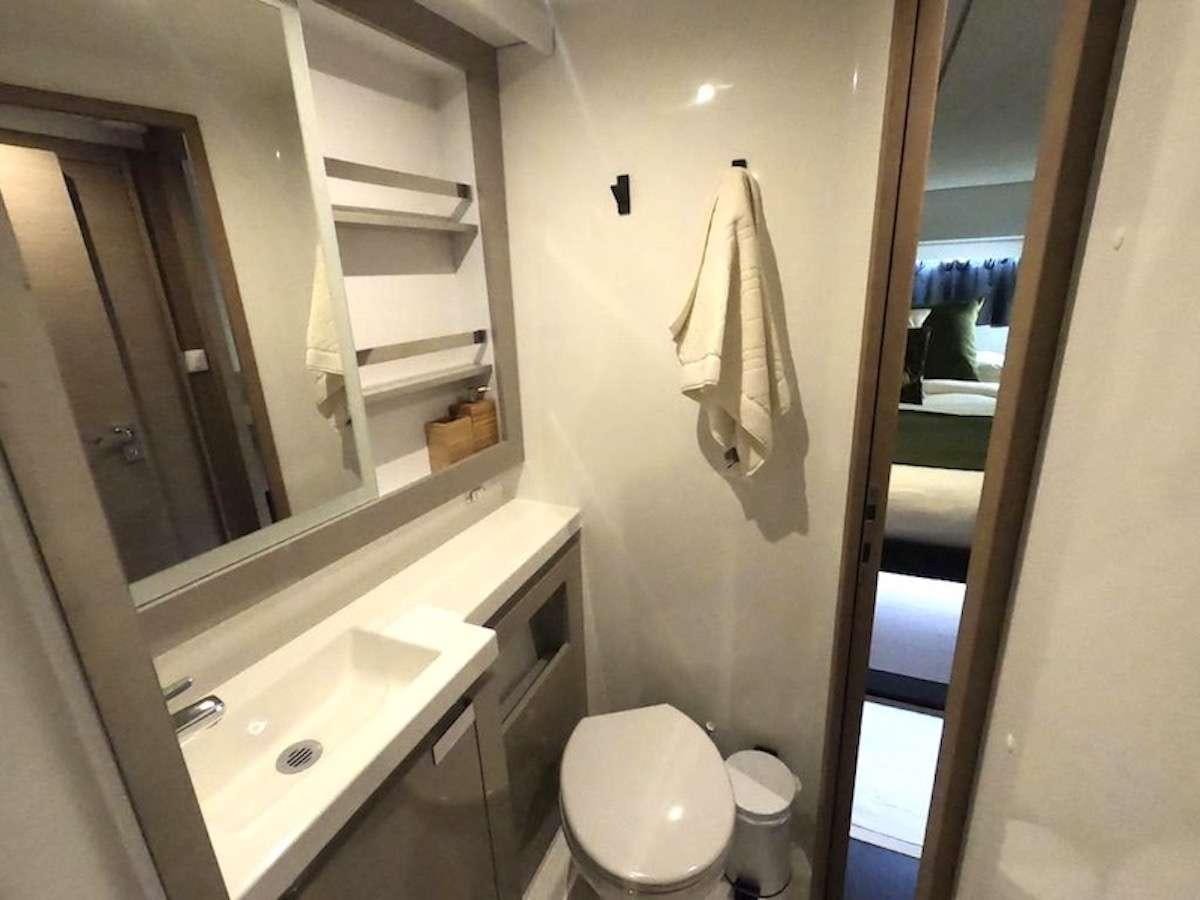 a bathroom with a sink and a toilet aboard CHAMPAGNE Yacht for Charter