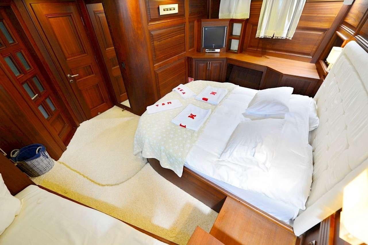 a bed with white sheets aboard MIA 1 Yacht for Charter