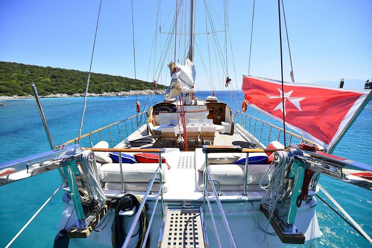 a boat with a flag on it aboard MIA 1 Yacht for Charter