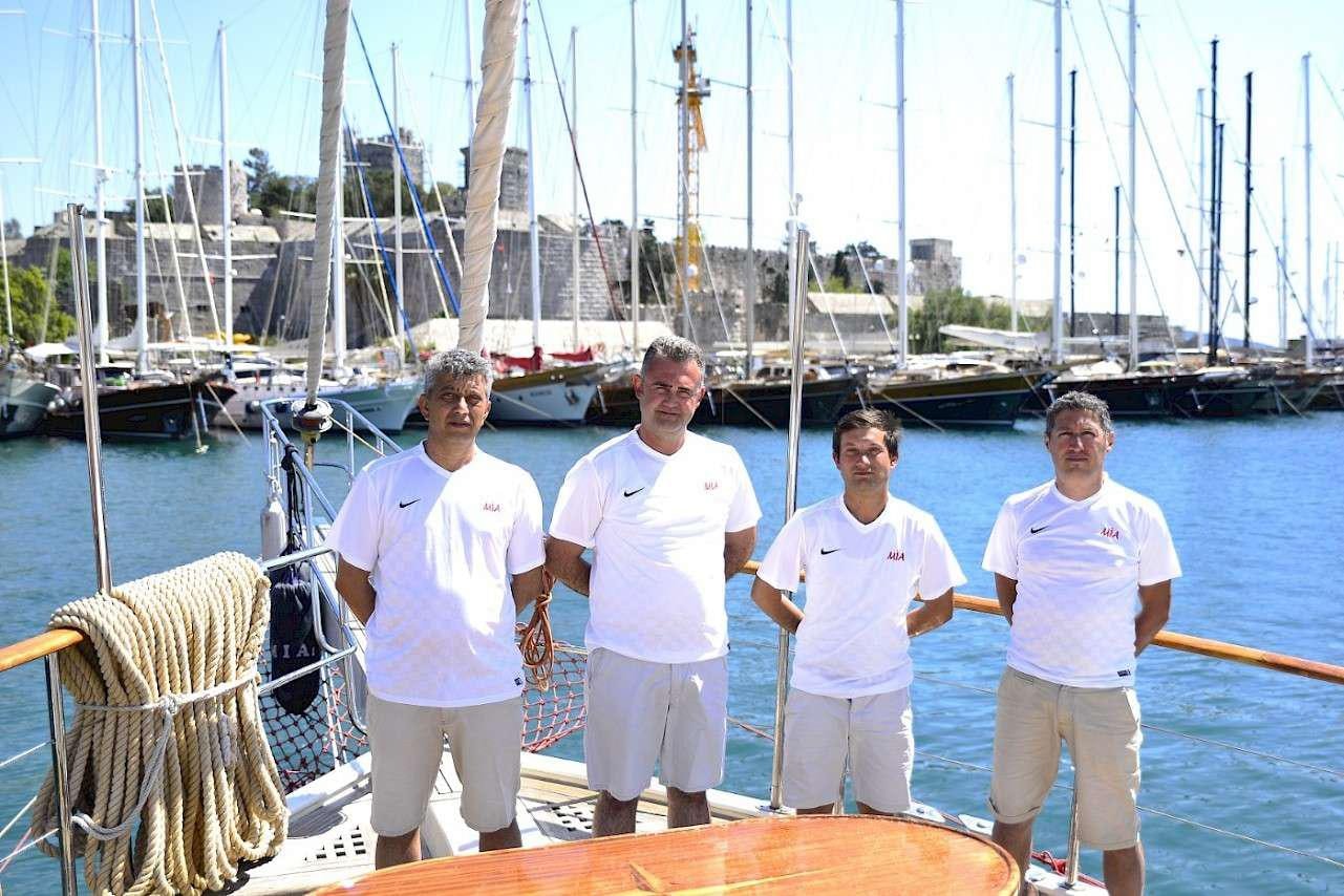 a group of people posing for a photo on a dock aboard MIA 1 Yacht for Charter