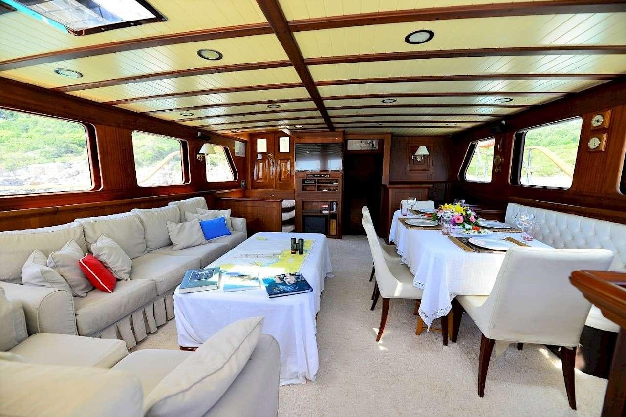 a living room with a couch and a table aboard MIA 1 Yacht for Charter