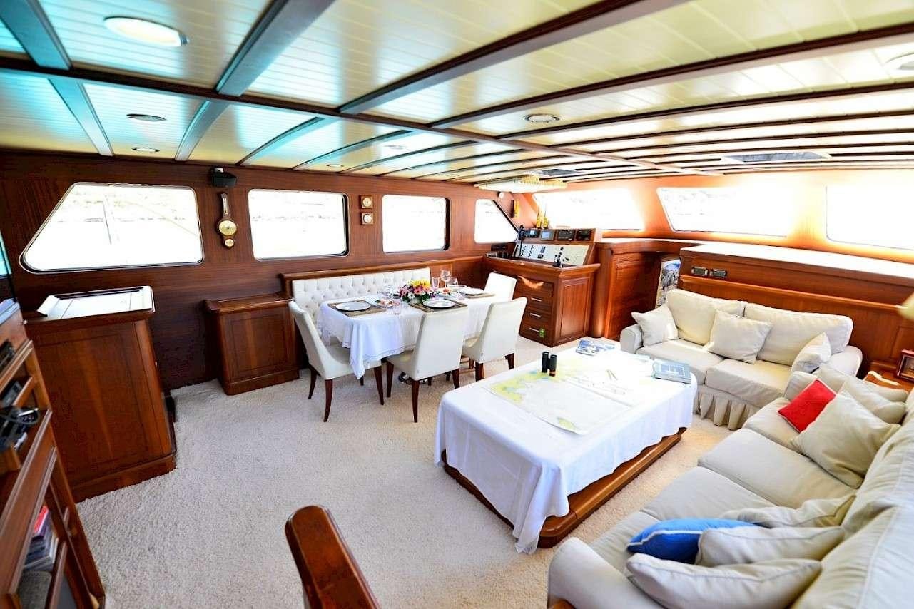 a room with a table and chairs aboard MIA 1 Yacht for Charter
