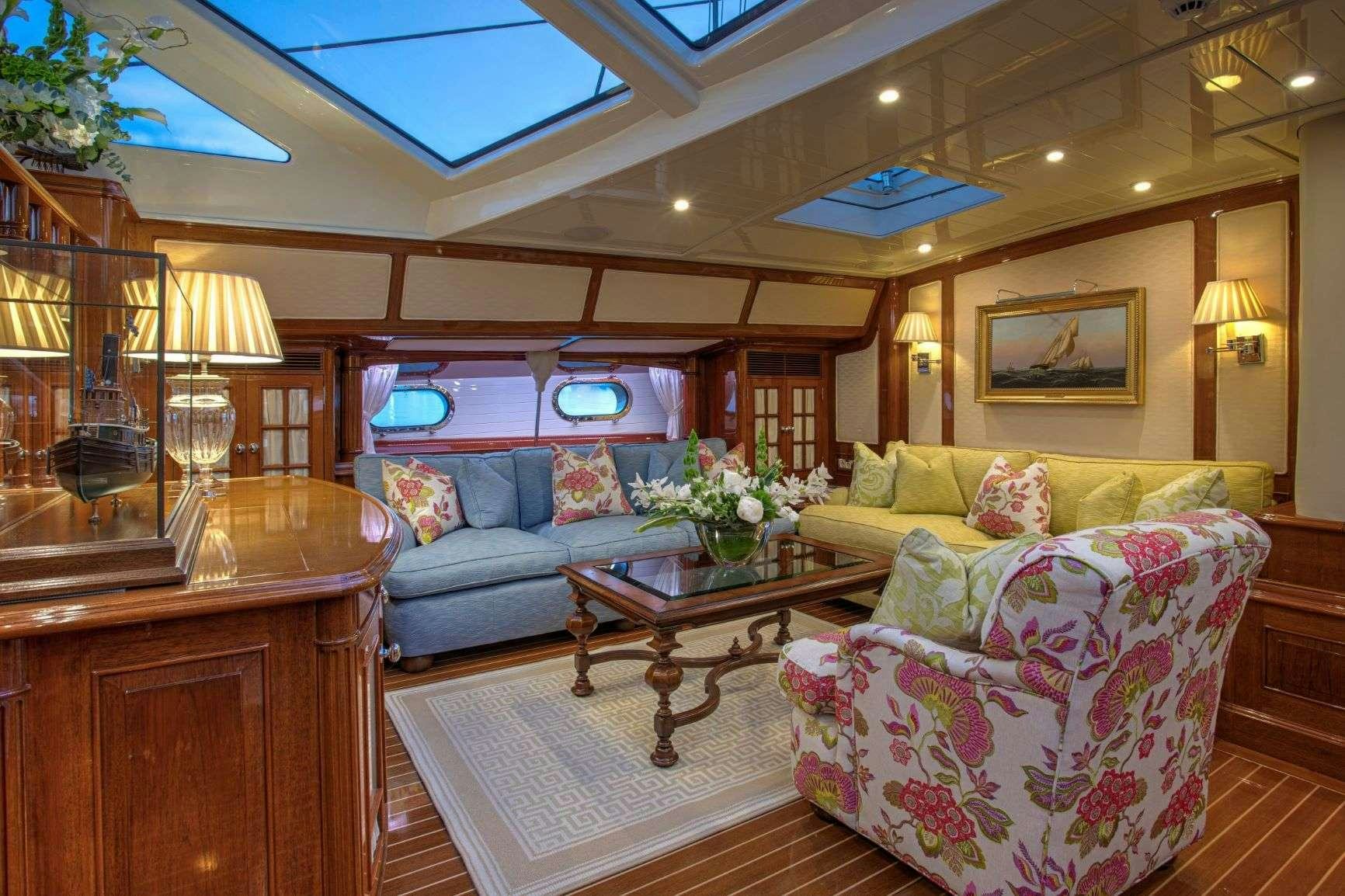 a living room with a couch and a coffee table aboard WHISPER Yacht for Charter