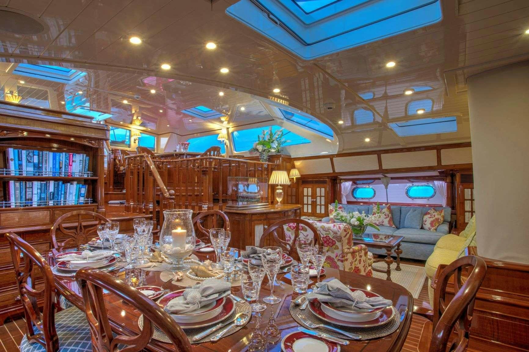 a room with tables and chairs aboard WHISPER Yacht for Charter