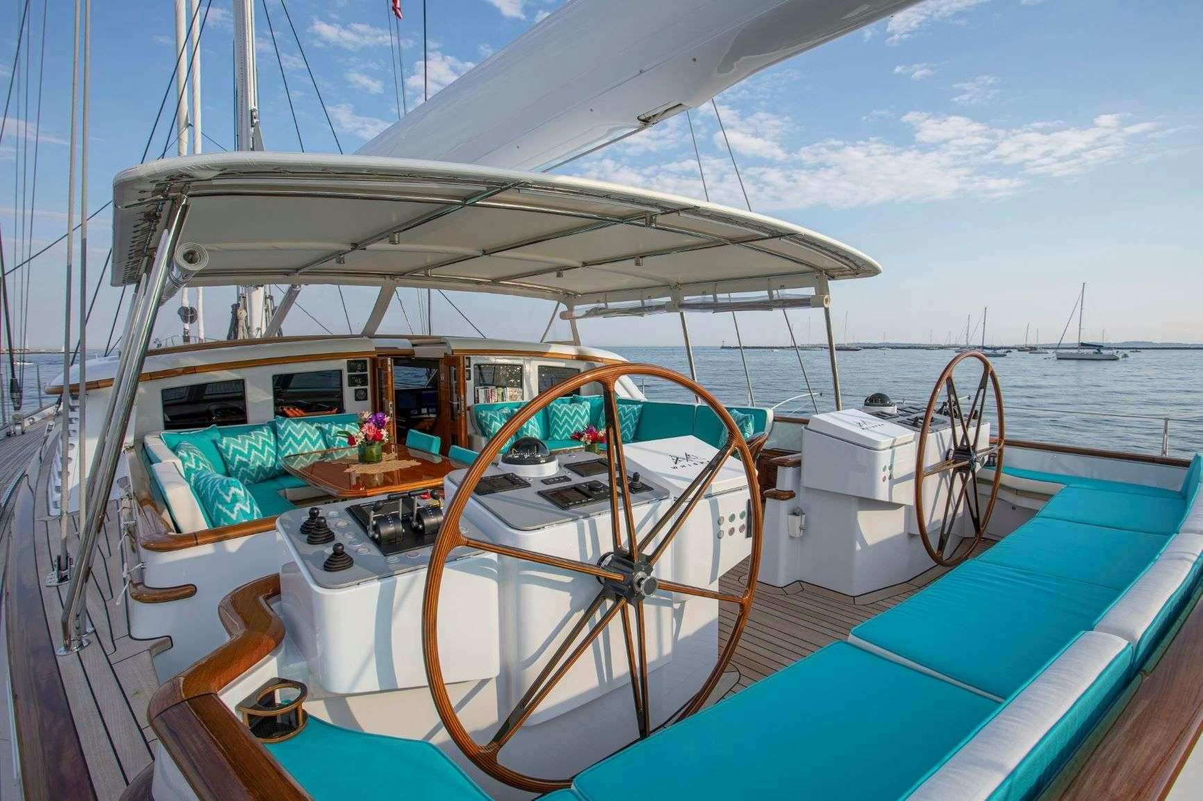 a boat with a large wheel aboard WHISPER Yacht for Charter