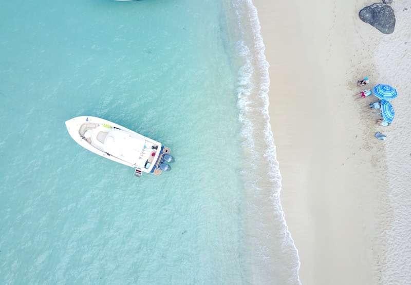 a white car on a beach aboard MIDNIGHT MOON Yacht for Charter