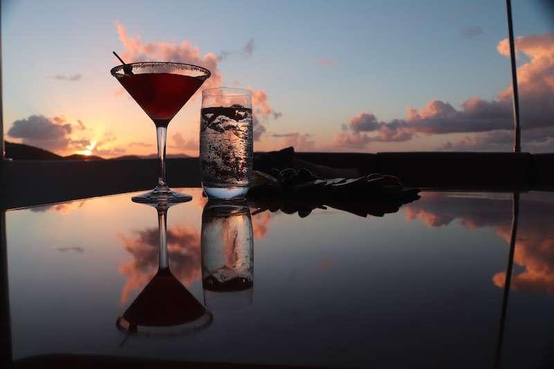 a glass of wine and a helicopter aboard MIDNIGHT MOON Yacht for Charter