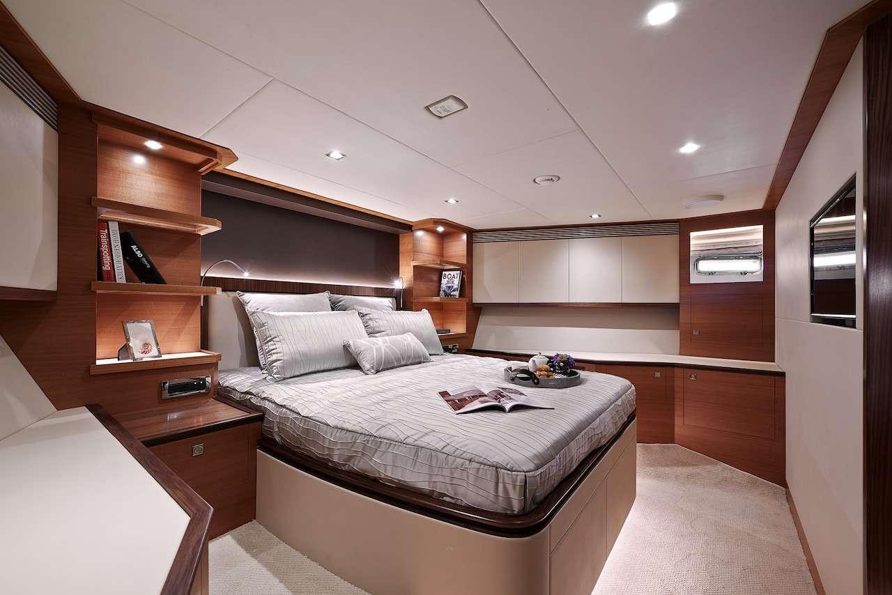 a bedroom with a bed and a bookcase aboard MIDNIGHT MOON Yacht for Charter