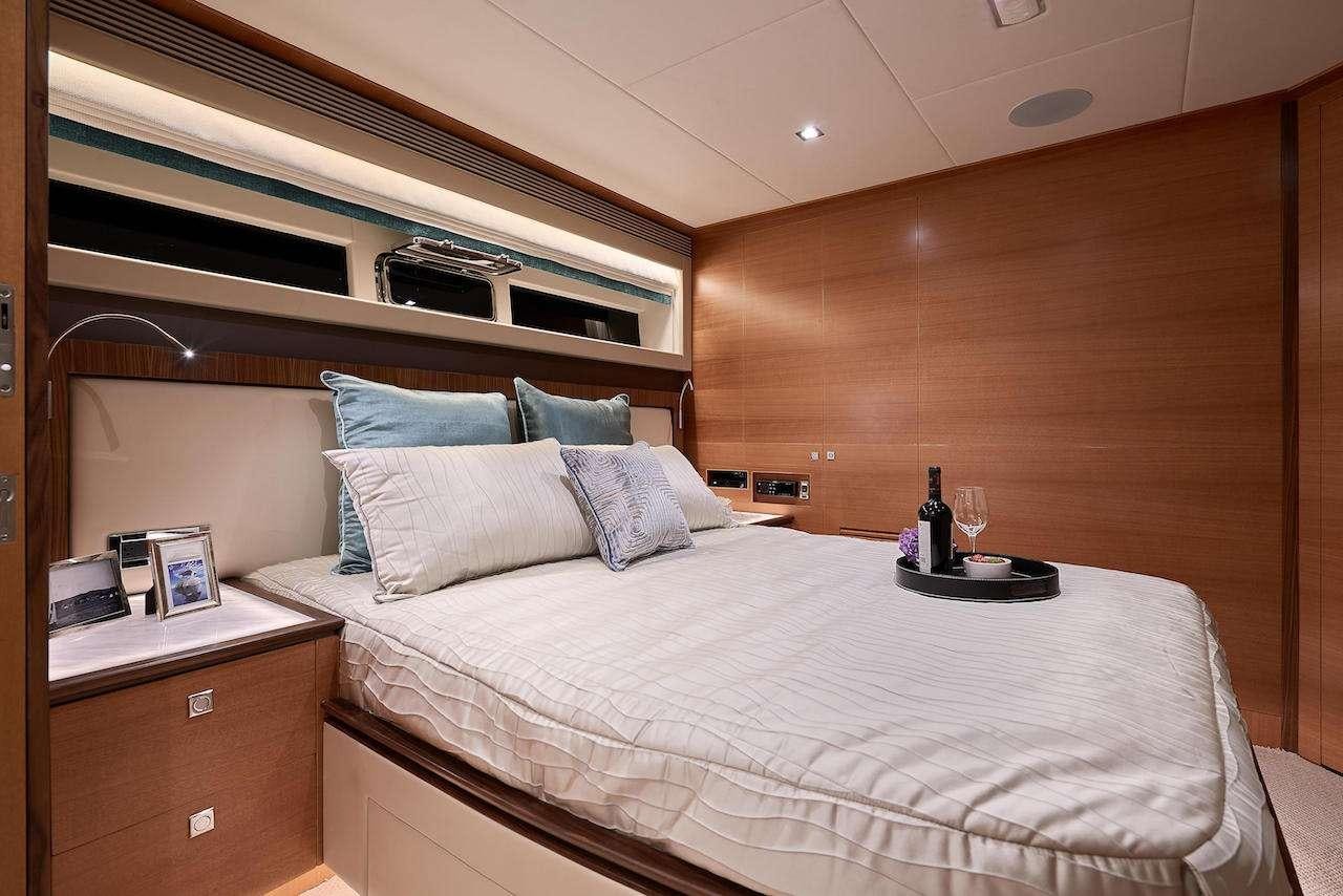 a bed with a white bed spread aboard MIDNIGHT MOON Yacht for Charter