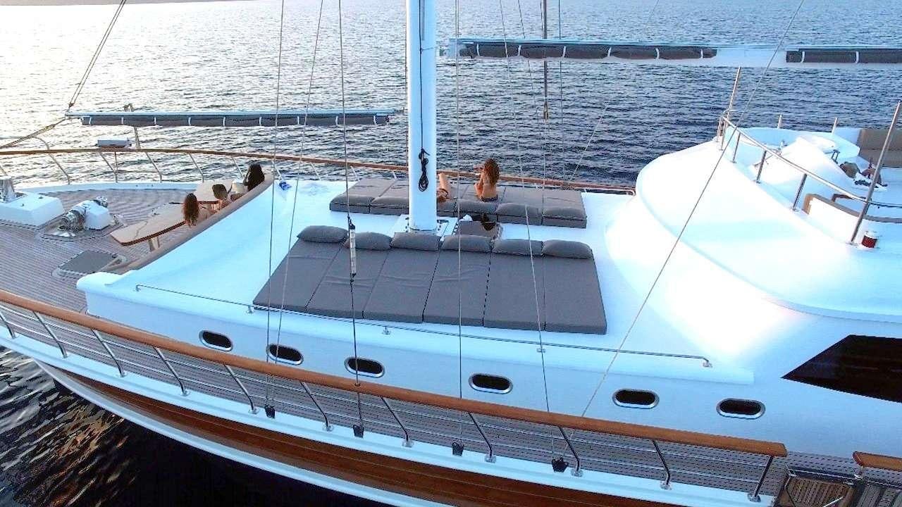 a white boat with a person sitting on it aboard SADIYE HANIM Yacht for Charter