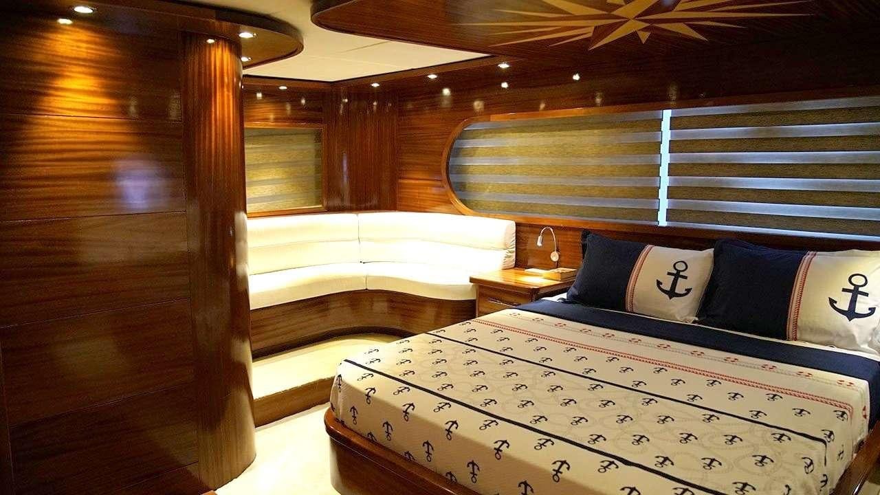 a room with beds and a window aboard SADIYE HANIM Yacht for Charter