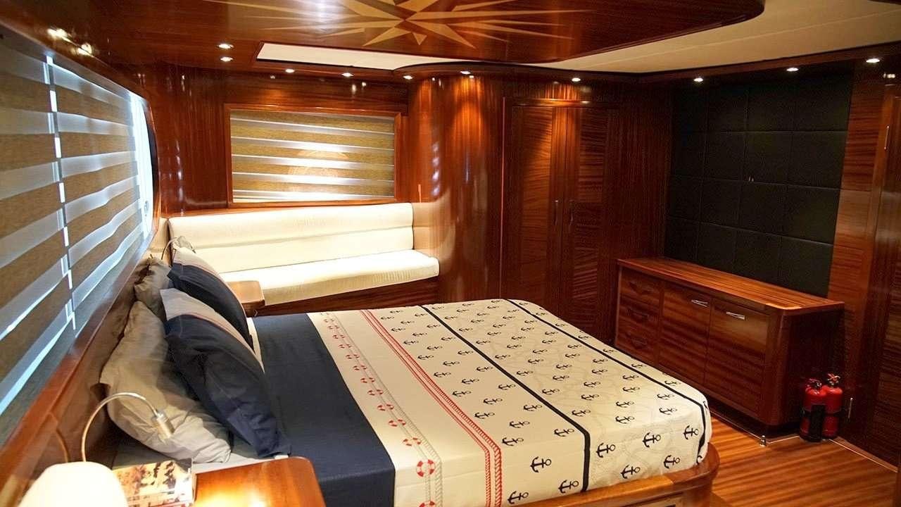 a room with a bed and a dresser aboard SADIYE HANIM Yacht for Charter