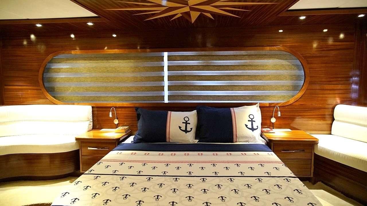 a bed with a white bed spread aboard SADIYE HANIM Yacht for Charter