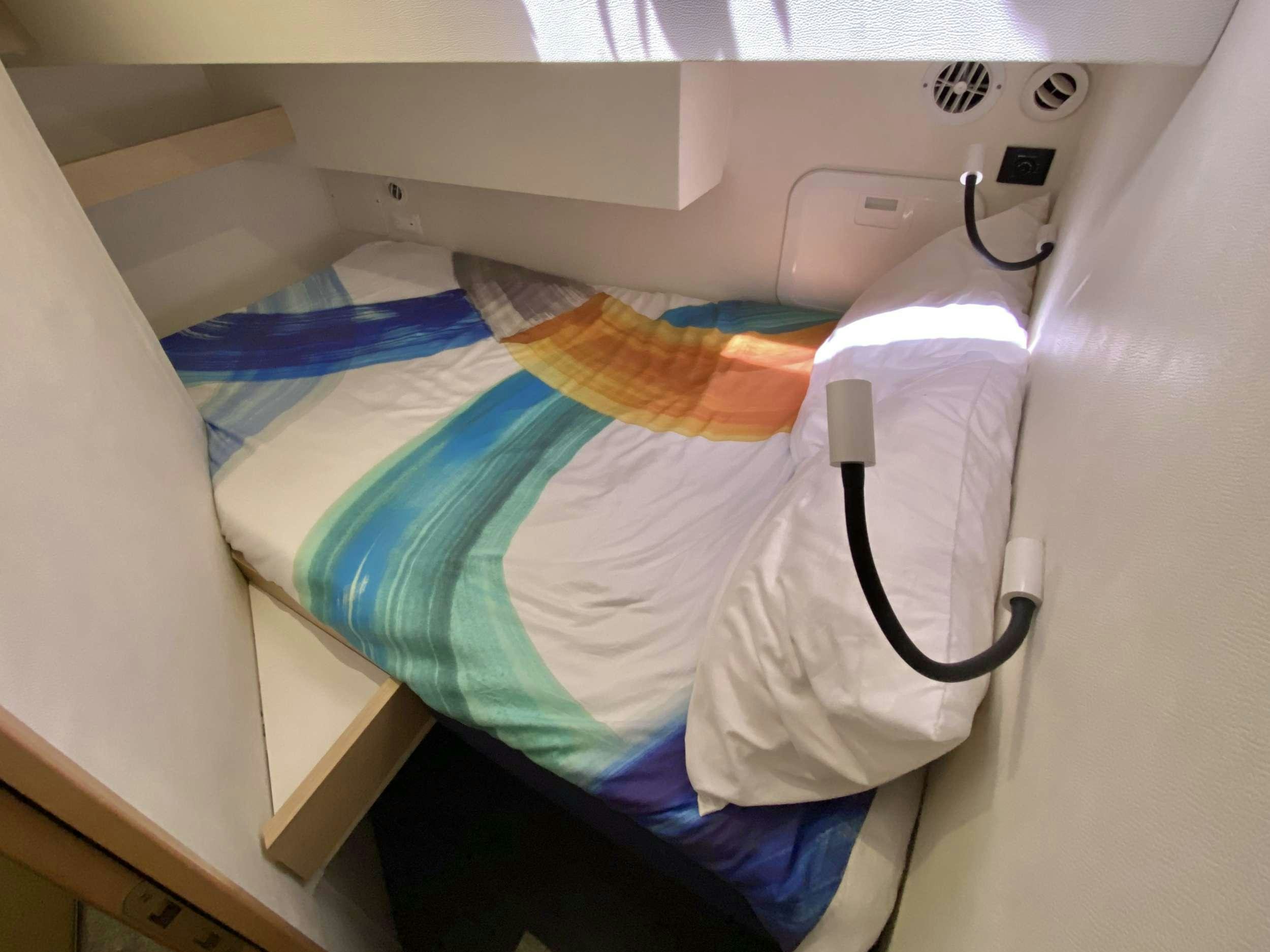 a hospital bed with a blue blanket aboard KATRINA Yacht for Charter