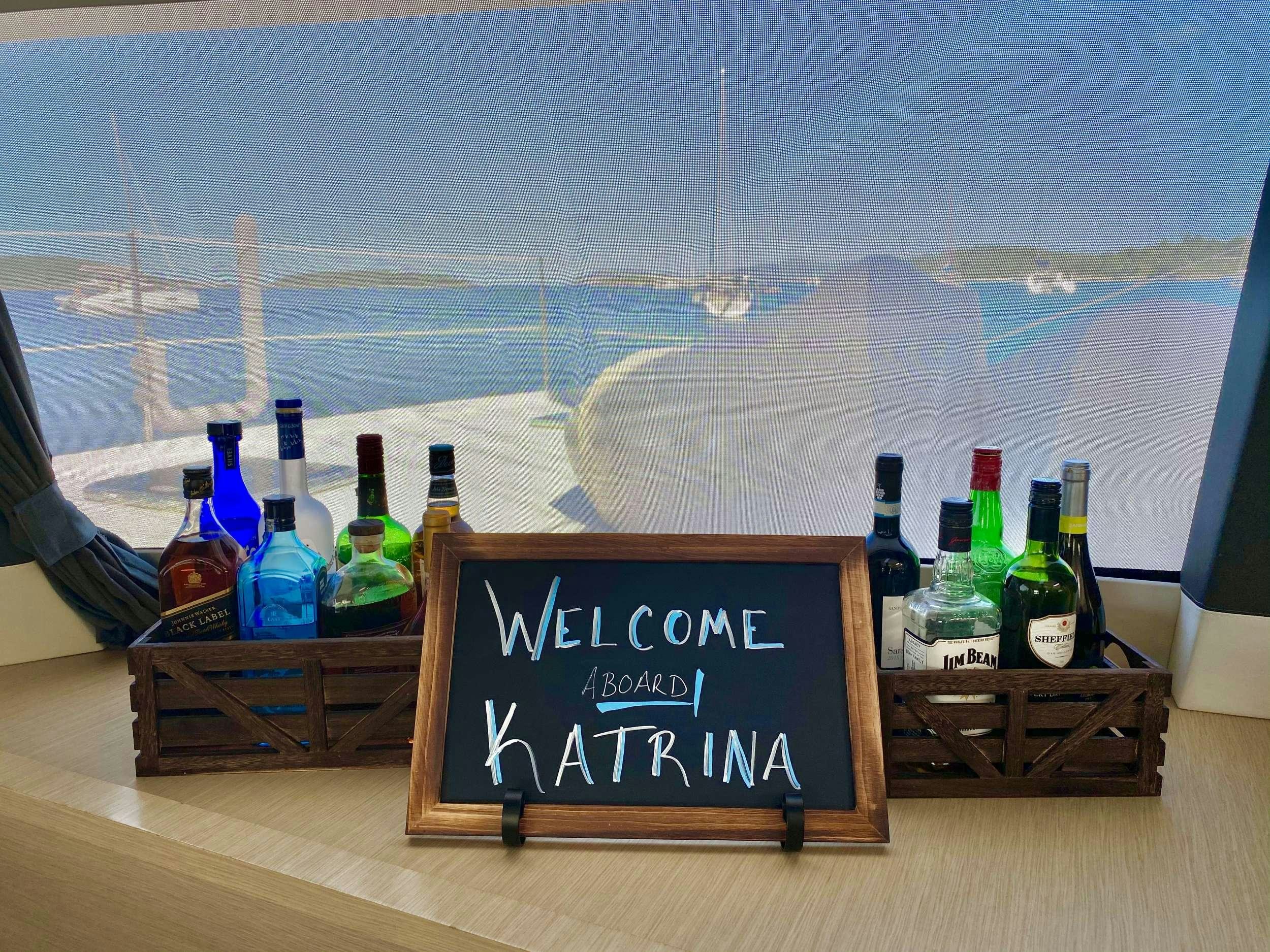 a bottle of wine and a menu on a table aboard KATRINA Yacht for Charter