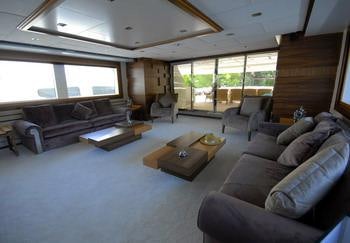 a living room with a large window aboard STEEL Yacht for Charter
