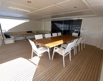 a room with tables and chairs aboard STEEL Yacht for Charter